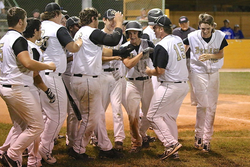 Image: Levi McBride(1) is congratulated by his Gladiator teammates after the sophomore recorded his second homer of the season.