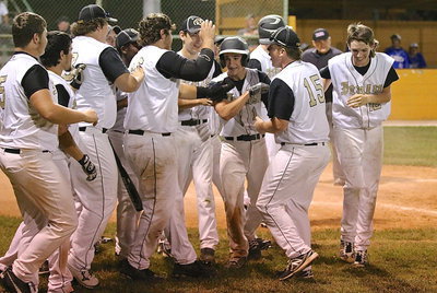 Image: Levi McBride(1) is congratulated by his Gladiator teammates after the sophomore recorded his second homer of the season.