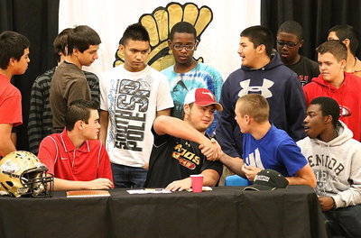 Image: Zain Byers is congratulated by junior high Gladiator Clay Riddle and several of Riddle’s teammates. Zain wishes the guys good luck next season as they follow in his cleat steps as incoming freshman.