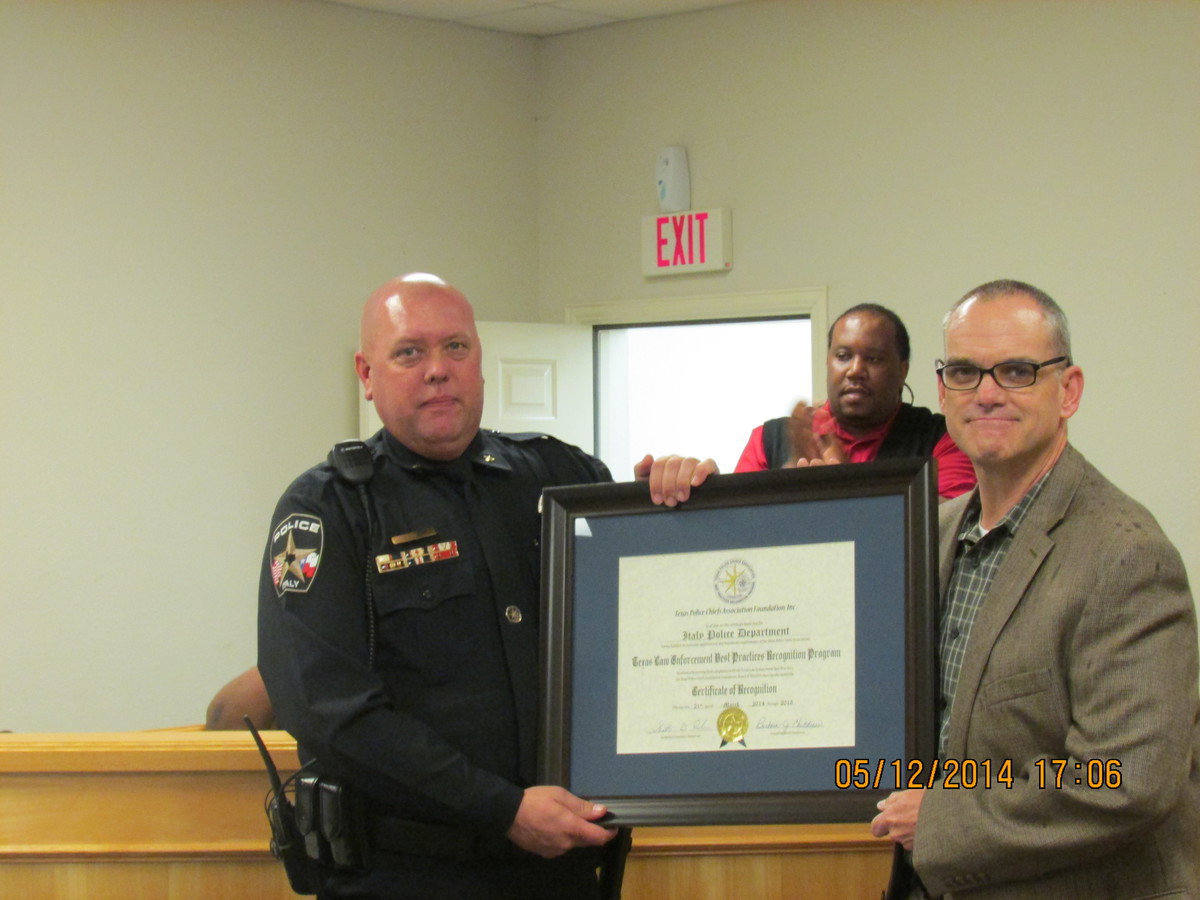 Image: Chief Diron Hill accepting award from Chief Michael Sullivan of Farmersville