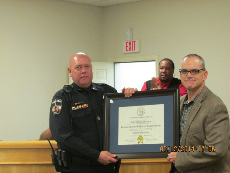Image: Chief Diron Hill accepting award from Chief Michael Sullivan of Farmersville