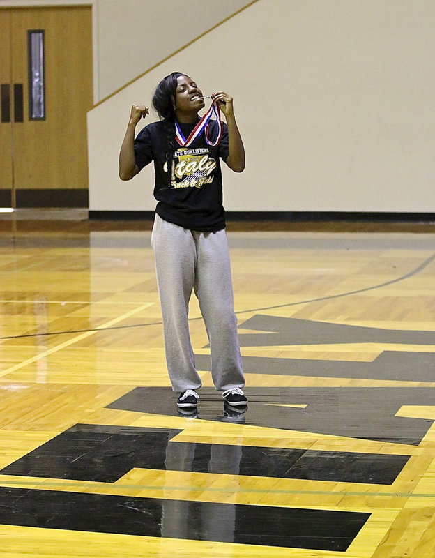 Image: Senior Kendra Copeland enjoys the taste of success after helping to bring home the silver medal as a part of Italy’s Girls Sprint Relay team.