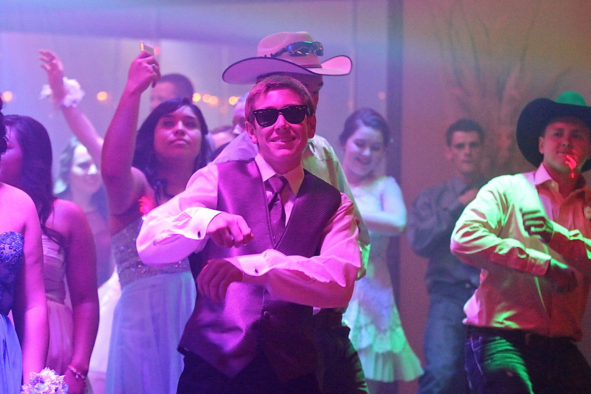 Image: Clayton Miller and Bailey Walton break it down for us while Monserrat Figueroa takes a prom selfie to capture the moment.