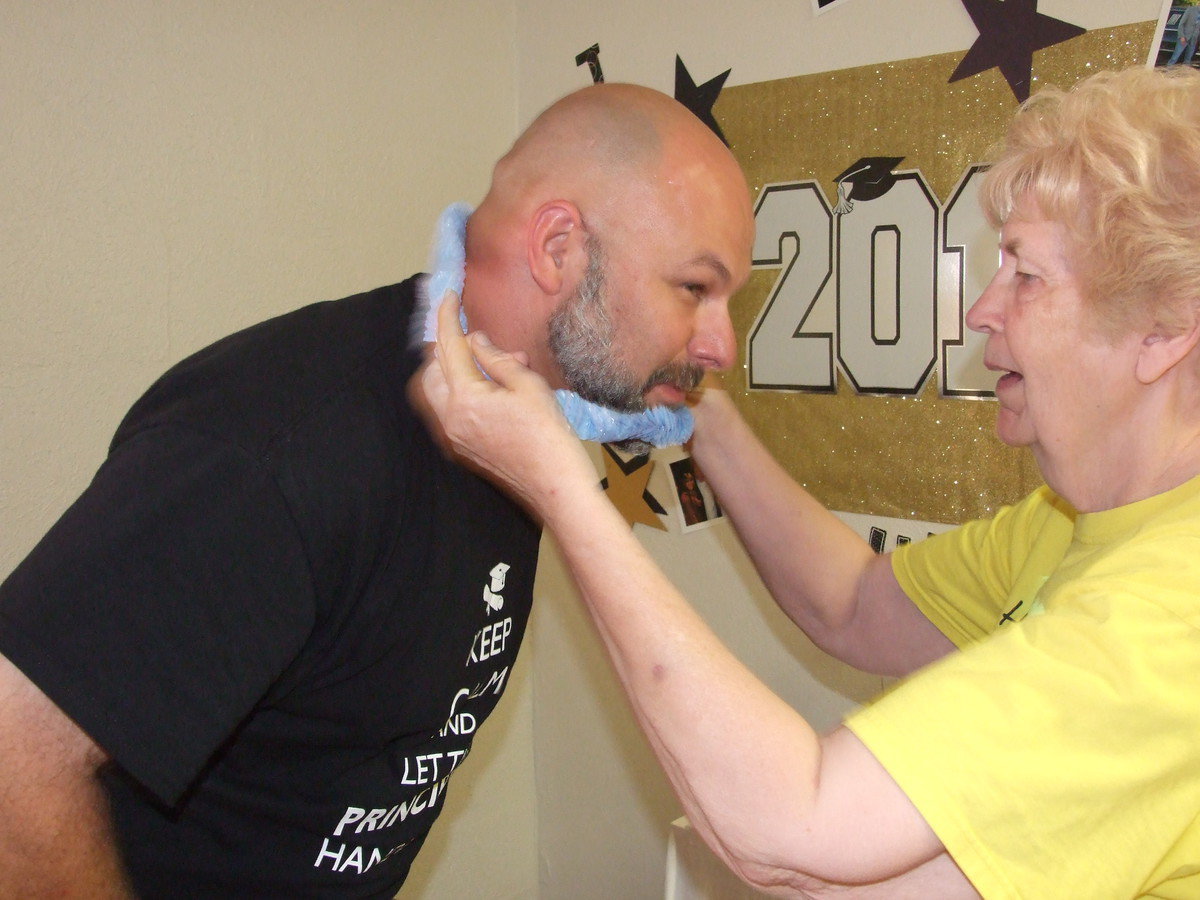 Image: Miss Birdie welcomes Principal Joffre with a Hawaiian lei.