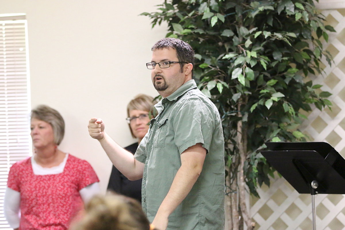 Image: Central Baptist Church Youth Minister Sean Horton welcomes the IHS graduates and then directs them to the food line.