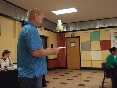 Image: Michael Chambers goes over the summer projects with the board.