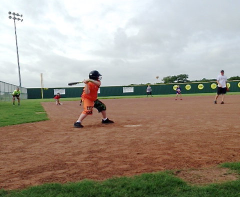 Image: Bryce Ballard sees a pitch he likes from Coach Jon Cady.