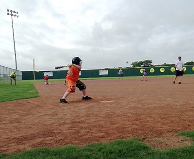 Image: Bryce Ballard sees a pitch he likes from Coach Jon Cady.