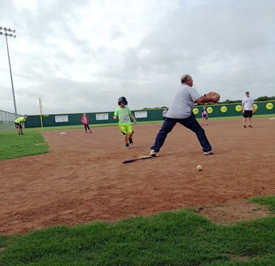 Image: Gladiator Baseball Coach Jackie Cate tries to make a stop at the plate.