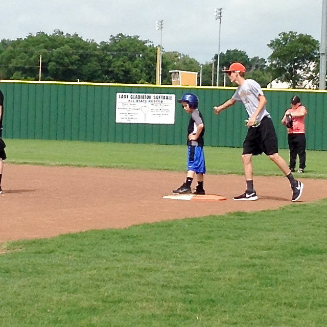 Image: Camp Coach Ty Windham congratulates his hitter.