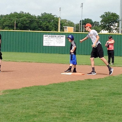 Image: Camp Coach Ty Windham congratulates his hitter.