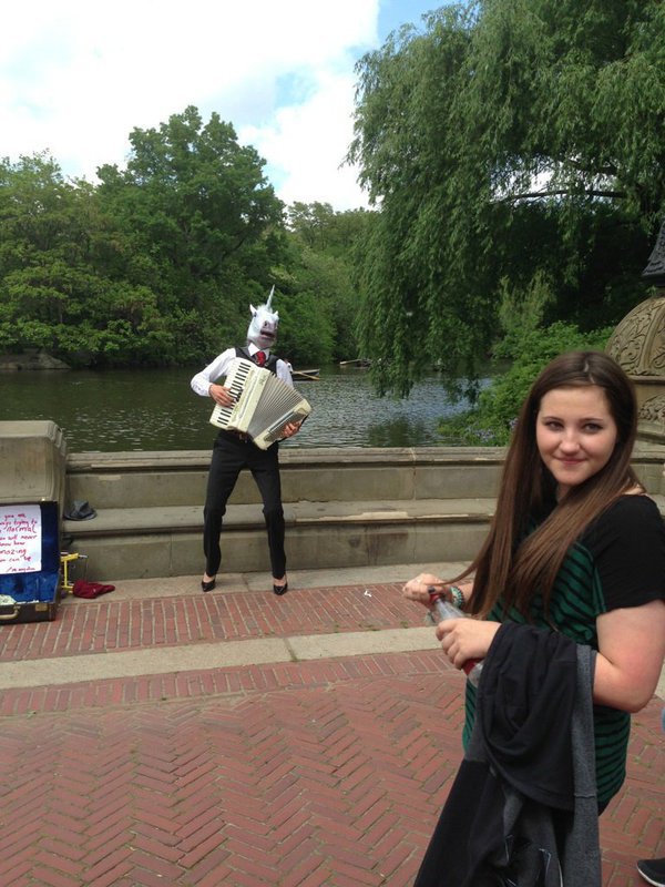 Image: Alexis Sampley is mesmerized by an accordion playing unicorn in high heels.