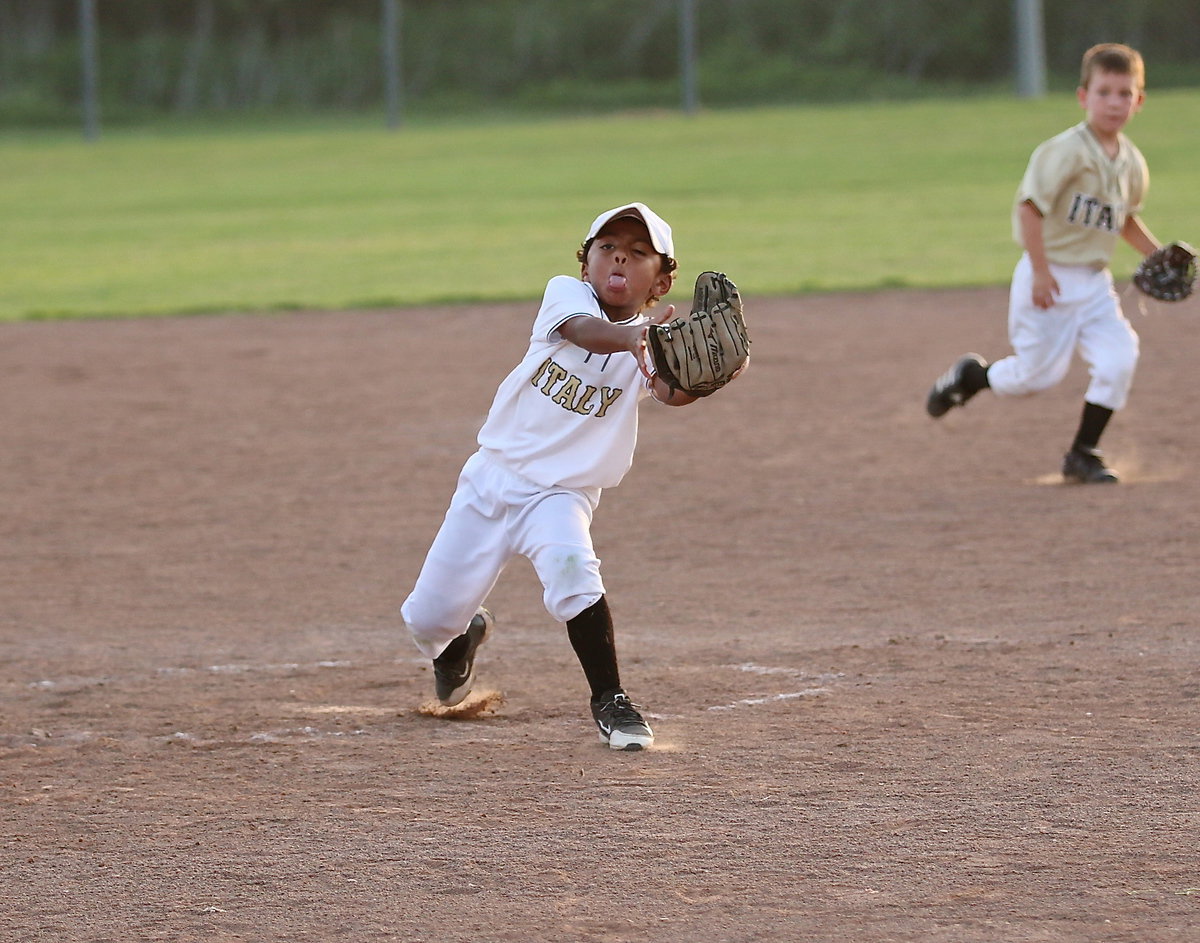 Image: Pitcher Cason Green(10) attempts to pull in a popup with one eye closed and a mouth full of dust.