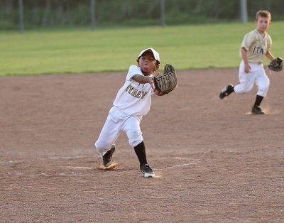 Image: Pitcher Cason Green(10) attempts to pull in a popup with one eye closed and a mouth full of dust.