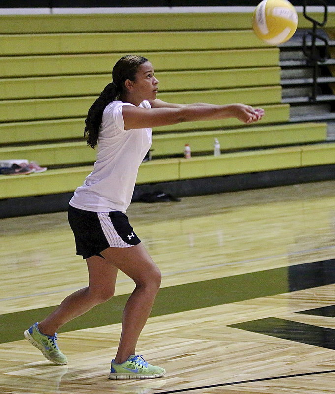Image: April Lusk bumps the ball up during a drill.