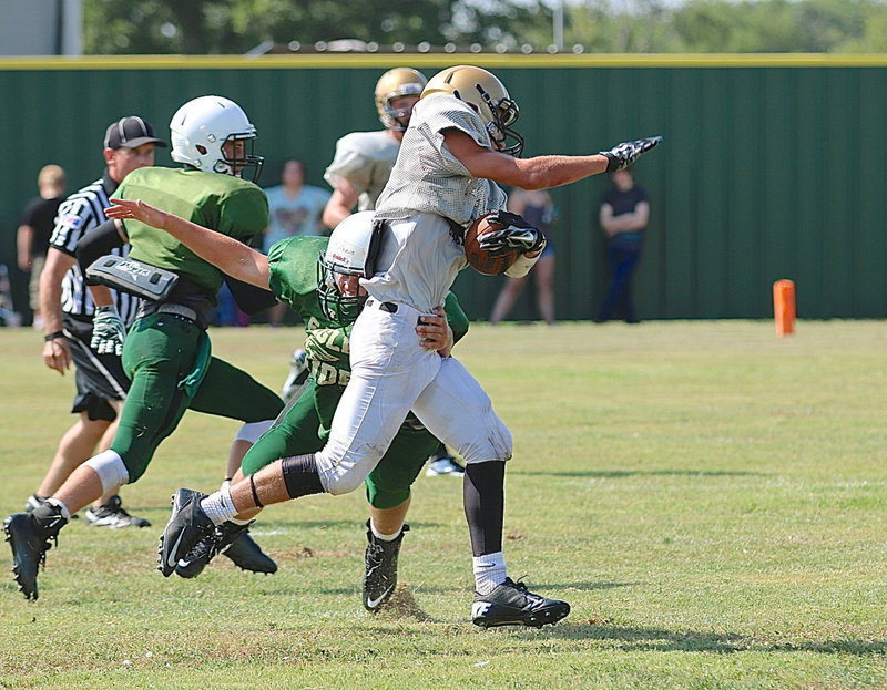 Image: Italy’s Levi McBride(2) breaks a tackle and then finishes off a 54-yard catch-and-run down to goal line.