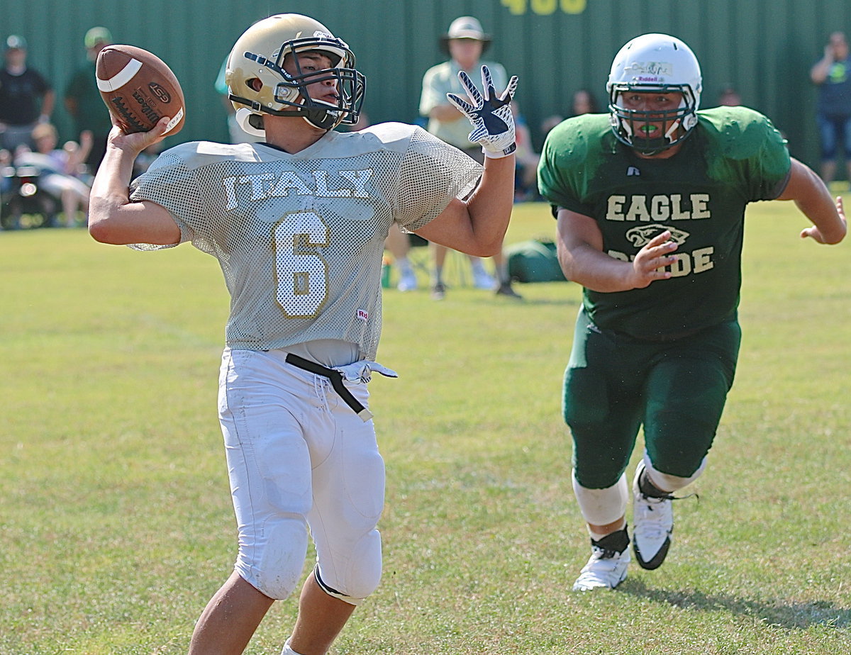 Image: Gladiator sophomore quarterback Joe Celis(6) completes a pass while under pressure.