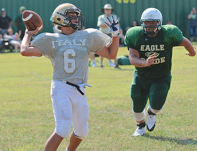 Image: Gladiator sophomore quarterback Joe Celis(6) completes a pass while under pressure.