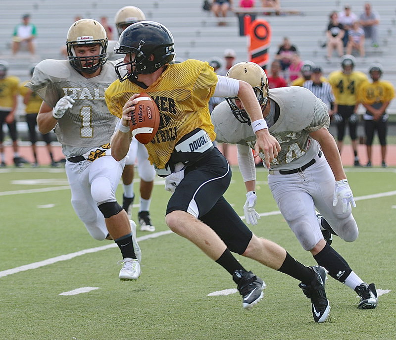 Image: Palmer quarterback Ty Mitchell (4) eludes Italy Dog Catchers Hunter Merimon(1) and Cody Boyd(34).