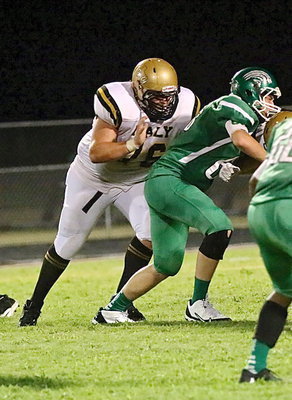 Image: Senior right offensive guard Colin Newman(76) zeroes in on a Bobcat defenseman.