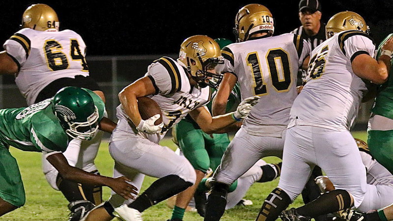 Image: Senior tailback, Hunter Merimon(3) searches for a running lane behind the blocking of Ty Fernandez(64), Coby Jeffords(10) and Colin Newman(76) during Italy’s 2014 season opener against the Kerens Bobcats.