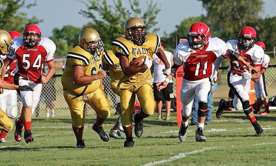 Image: He gone! — Italy’s Gabe Fernandez(62) clears a path for teammate Jaray Anderson(10) who breaks thru for a long run against the Panthers.