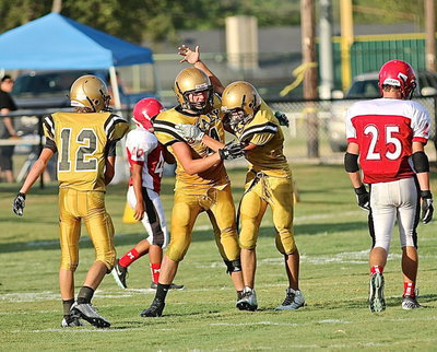 Image: Garrett Janek(12) and Dylan McCasland(3) congratulate Micah Escamilla(4) after making a catch downfield.