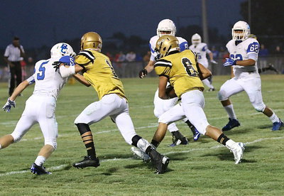 Image: Italy receiver Levi McBride(1) blocks downfield to help teammate Joe Celis(8) keep for more yards.