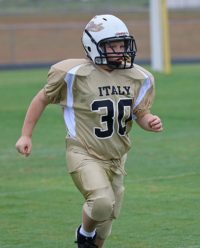 Image: B-team Gladiator Bryce Ballard(30) rumbles onto the field to take on the Rice Bulldogs.