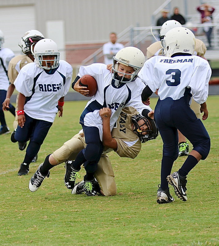 Image: B-team Gladiator Gabe Martinez(4) brings down a Bulldog runner.