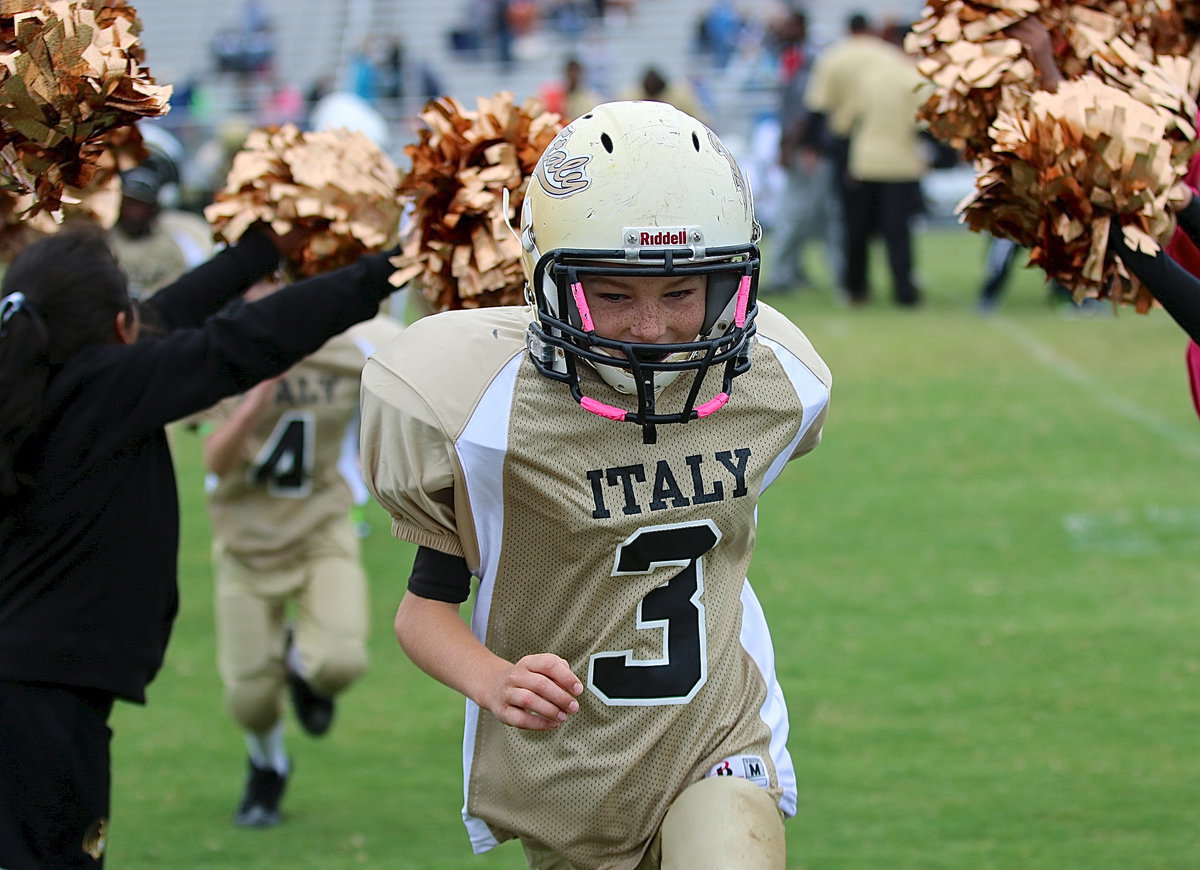 Image: Taylor Sparks(3) enjoys running thru spirit alley created by the IYAA B-team cheerleaders.