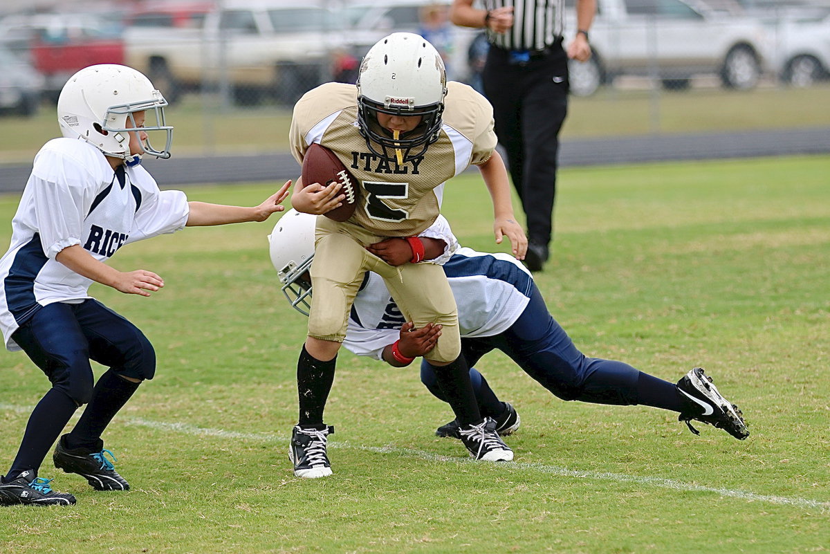Image: B-team Gladiator, Gabe Martinez(5) rumbles and stumbles thru Bulldog tacklers for a 1st down run late in the contest.