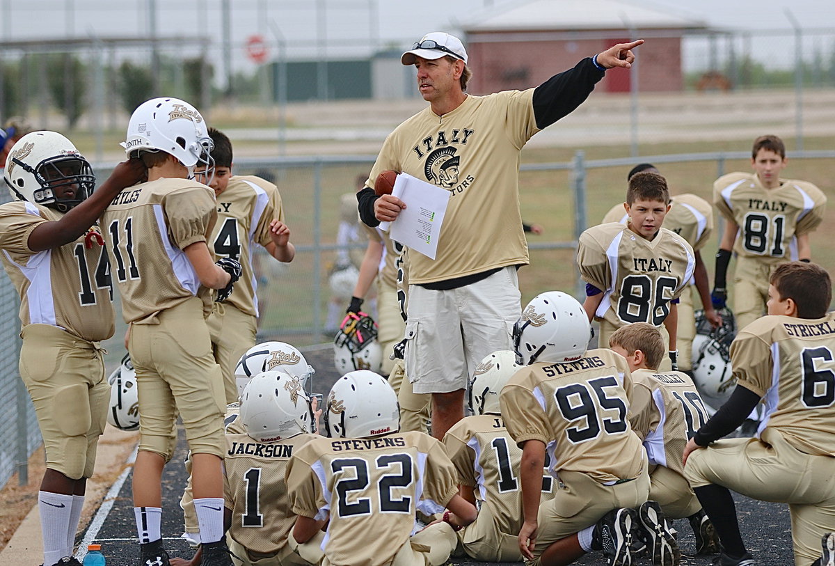Image: IYAA President and A-Team Gladiators’ (5th-6th) head coach, Charles Hyles prepares to lead his squad into opening day battle against Rice.