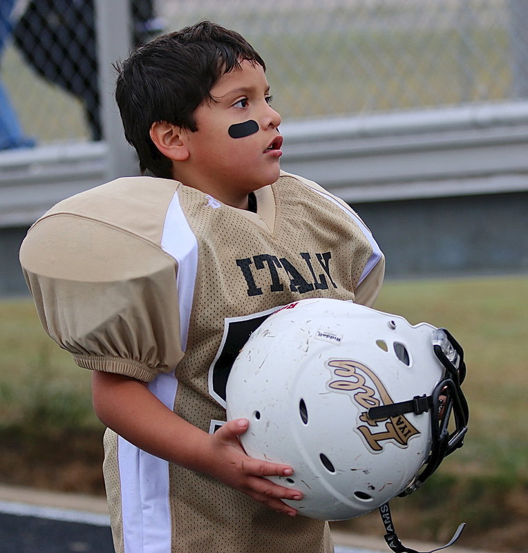Image: C-team Gladiator Gavin Vasquez(56) looks to the stands for approval from his family after his team’s 20-0 victory over Rice.