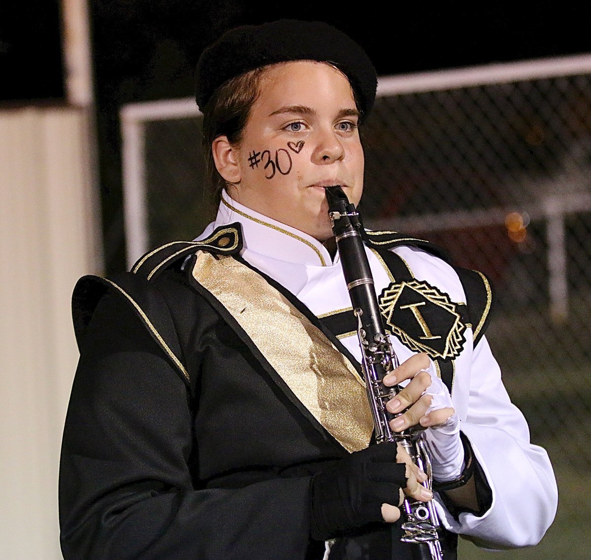 Image: Christy Murray warms up before the halftime show with her band mates.