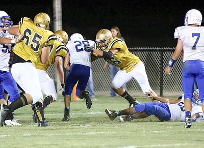 Image: Italy defensive end David De La Hoya(56) fights off a block to make a tackle.