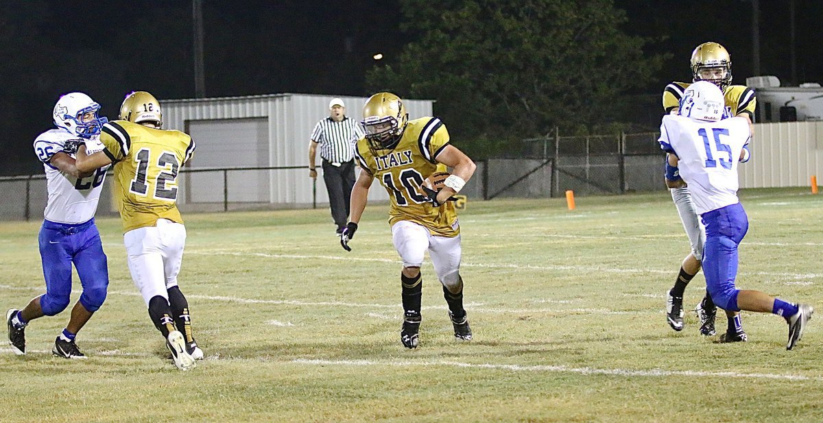 Image: More downfield blocking by Kyle Tindol(12) and Ryan Connor(7) paves the way for Coby Jeffords(10) and another long gainer for the Gladiators.