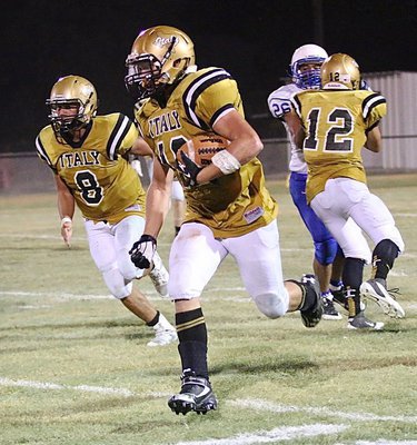 Image: Joe Celis(8) joins the convoy as Kyle Tindol(12) keeps on blocking and Coby Jeffords(10) jeeps on trucking for the Gladiators.