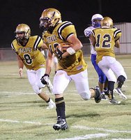 Image: Joe Celis(8) joins the convoy as Kyle Tindol(12) keeps on blocking and Coby Jeffords(10) jeeps on trucking for the Gladiators.