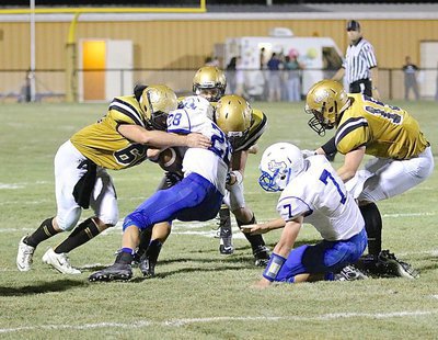 Image: Linebackers Kyle Fortenberry(66) and Coby Jeffords(10) join forces against a Frost runner.