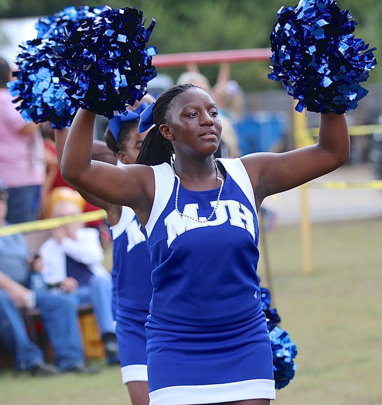 Image: Milford’s Junior High Cheerleaders help get the pep rally rocking as Tyneesia Rogers pom-poms to a Bulldog beat.