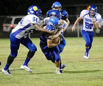 Image: Bulldog ball carrier Jaquay Brown(11) bullies his way thru a pair of Oakwood tacklers. Brown recorded 143 rushing yards on 13 carries (11.0 average) and 4 touchdowns.