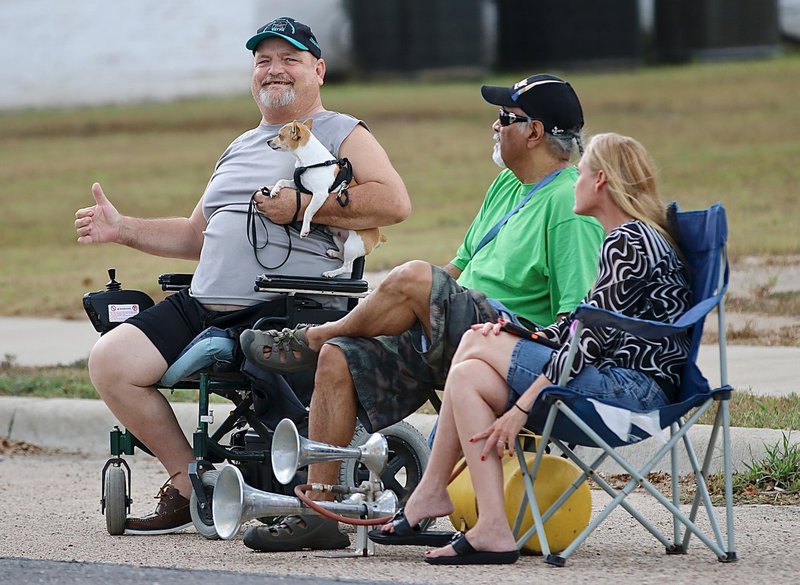 Image: T.J. and his friends make some noise during the homecoming parade with an obnoxiously loud air horn and a tiny dog, with a louder than normal bark, for the Bulldogs.