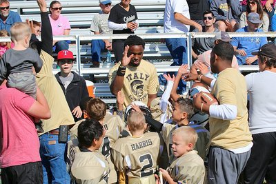 Image: IYAA C-team Gladiator head coach Jasenio Anderson, offensive coordinator Gary Wood and special teams coach Andre Speed break the huddle victorious!