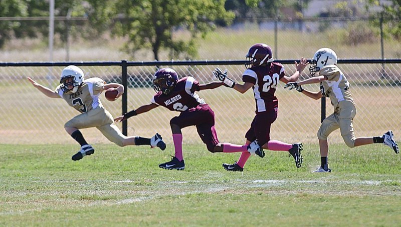 Image: IYAA A-team Gladiator Ty Cash(3) strectches for every inch he can get after a long run.