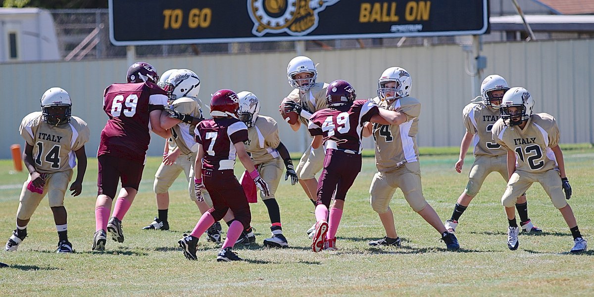 Image: A-team Gladiator Creighton Hyles(11) enjoys a perfect passing pocket while scanning the field for an open receiver.