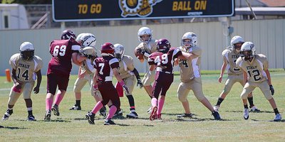 Image: A-team Gladiator Creighton Hyles(11) enjoys a perfect passing pocket while scanning the field for an open receiver.