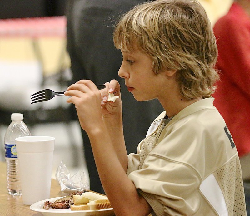 Image: Chase Hyles enjoyes the brisket served by Bubbas Barbecue.