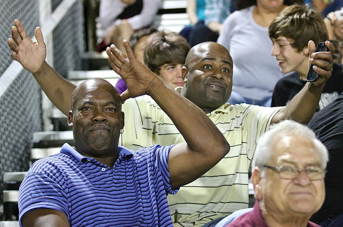 Image: Kenneth Norwood, Sr., and Mailen Davis are a couple of proud fathers enjoying the homecoming win.