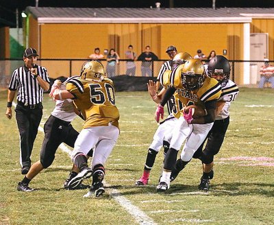 Image: John Escamilla(50) blocks a Bulldog while out-of-bounds in an effort to spring Kendrick Norwood(4) down the Italy sideline during a kick return.
